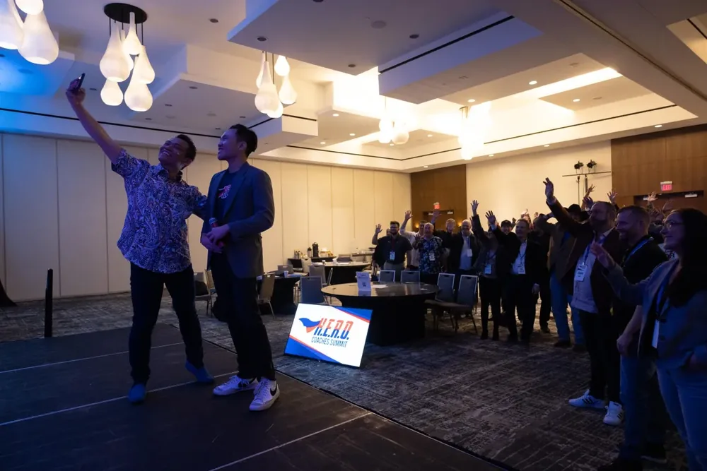 Ben Hoang speaking on stage at a wholesaling event